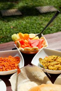 a table topped with bowls of different types of food at Bay Hiriketiya in Hiriketiya