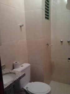 a bathroom with a toilet and a shower at Hotel Imperador in Caldas Novas