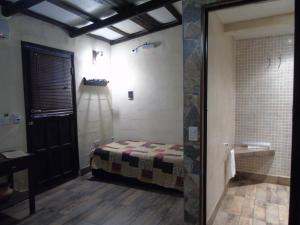 Habitación con cama y baño con ducha. en Abuela Faustina in 