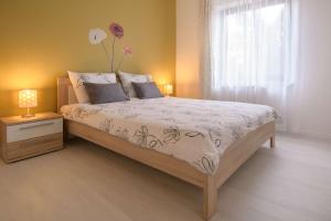 a bedroom with a bed with a vase on top of it at Apartment Motovunska 39 in Poreč