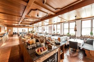 a restaurant with a bar with food on it at Hotel Ariadne in Rosenheim