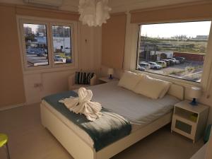 a bedroom with a bed and a large window at Bettys 1br seafront apt in Larnaca