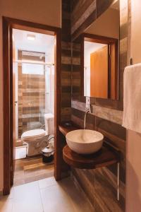 a bathroom with a sink and a toilet at Pousada Moquirido in Florianópolis