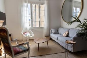 a living room with a couch and a mirror at La terrasse de Tiss in Bédoin