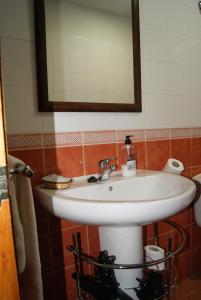a bathroom with a white sink and a mirror at APARTAMENTO 2 4/6 PAX CASA RURAL EL SAUCE. A 2,5 KM DE CUENCA CAPITAL in Nohales