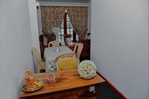 a room with a table and a dining room with a table and chairs at Kandy My Home stay in Kandy