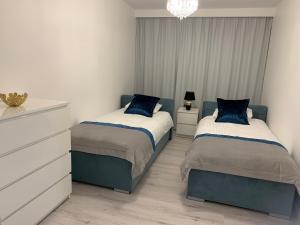 Posteľ alebo postele v izbe v ubytovaní Apartament Zacisze De LUX