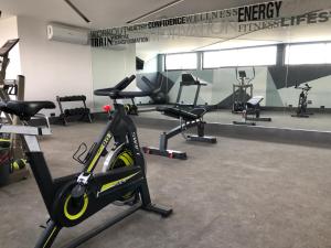 a gym with a bike and several exercise bikes at Hotel Isabel in Puebla
