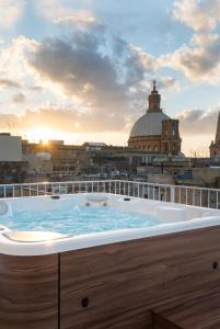 a large swimming pool with a large clock on top of it at The Barrister Hotel in Valletta