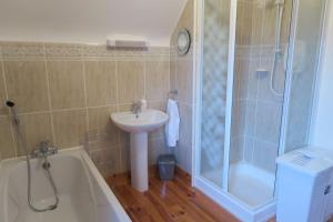 a bathroom with a tub and a sink and a shower at INGLEWOOD - Ballina - Crossmolina - County Mayo - Sleeps 8 - Sister property to Thistledown in Mayo