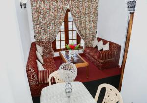 a living room with two chairs and a table at Kandy My Home stay in Kandy