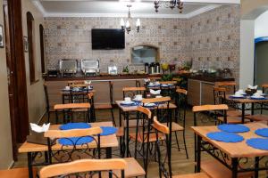 a dining room with tables and chairs and a bar at Pousada Portugal in Rio de Contas