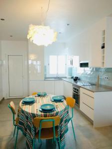 a kitchen with a table with chairs and a chandelier at Playa 2 in Níjar