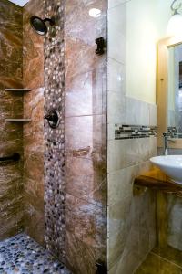 a bathroom with a shower and a sink at Adirondack Spruce Lodge in Wilmington