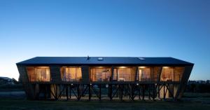 ein großes Haus mit vielen Fenstern in der Unterkunft Cabaña Eco Loft Chiloe Chonchi in Chonchi