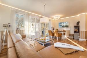 a living room with a couch and a dining room at Villa Strandblick in Zingst