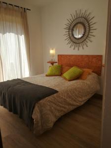 a bedroom with a large bed with a mirror on the wall at Apartamento Santa in Alicante