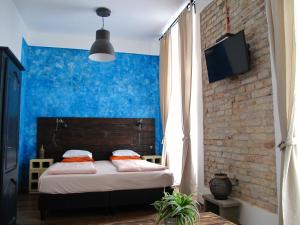 a bedroom with a bed and a window at Hedonist Lodge in Budapest