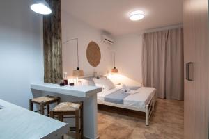a hotel room with a bed and a desk at Kallisti Studios & Apartments in Skiros