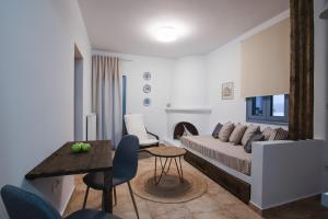 a living room with a couch and a table at Kallisti Studios & Apartments in Skiros