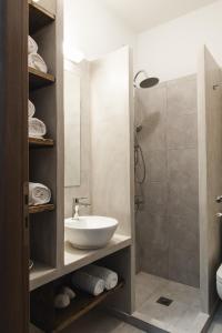a bathroom with a sink and a shower at Kallisti Studios & Apartments in Skiros +36 photos