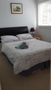 a bedroom with a large bed with a blanket at Quiet house beside Stansted Airport in Bishops Stortford