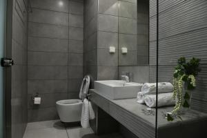 a bathroom with a sink and a toilet at City Heart Luxury Studios in Rhodes Town +41 photos