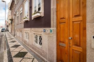 a wooden door on the side of a building at Fishtail Sea House in Matosinhos