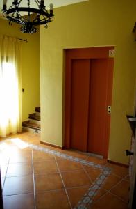 a hallway with a door and stairs in a house at Balcón de los Montes in Colmenar