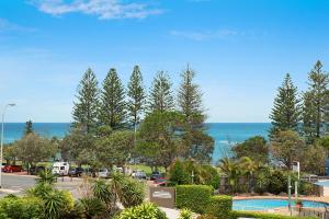 a view of a parking lot and the ocean at Joanne Apartments in Caloundra