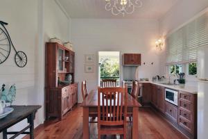 a kitchen with a wooden table and a dining room at Mango Hill Farm in Peachester