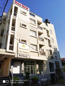 a white building with a sign in front of it at Livi Suites - Premium 1 BHK Serviced Apartments in Bengaluru