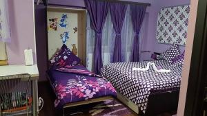 a purple bedroom with two beds and curtains at Garsoniera Cristina in Baile Felix