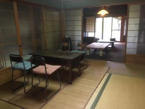 a room with a table and chairs in a room at Guesthouse Fuki Juku in Fuki