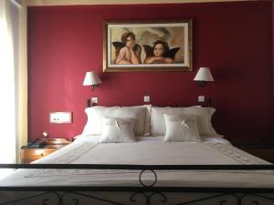 A bed or beds in a room at Kouros Hotel