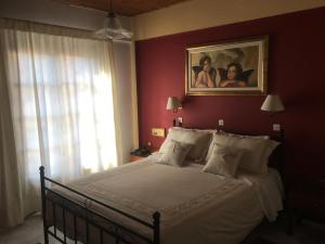 A bed or beds in a room at Kouros Hotel