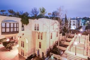 an overhead view of a building with a courtyard at Jacuzzi & Secret Garden in David's Village by FeelHome in Jerusalem