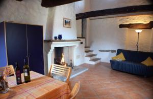 a living room with a table and a fireplace at Agriturismo Alla Vecchia Quercia in Pergola