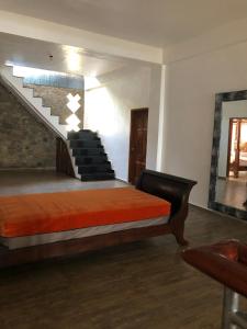 a bedroom with a bed and a stair case at Marie'z Villa in Tuktuk Siadong