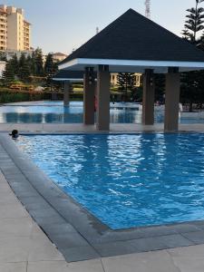 a swimming pool with a gazebo in a city at SMDC Cool Jane's Condo in Tagaytay