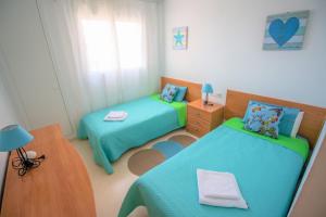a small room with two beds and a table at Residence Vacanza Torre Monaco in Benidorm +29 photos