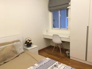 a bedroom with a bed and a desk and a chair at 84 Trần Phú Căn hộ in Vung Tau +17 photos