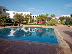 a swimming pool in front of a building at Résidence Tafoult Imiouadar près de Taghazout Agadir in Agadir nʼ Aït Sa