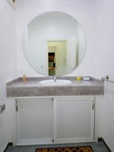 a bathroom with a sink and a mirror at Résidence Tafoult Imiouadar près de Taghazout Agadir in Imi Ouaddar