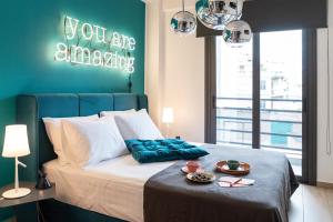 a bedroom with a bed with a green accent wall at 14 Reasons Why Hotel Athens in Athens