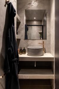 a bathroom with a sink and a bath tub at 14 Reasons Why Hotel Athens in Athens