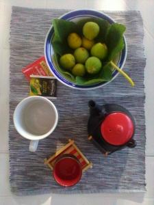 a table with a bowl of fruit and a cup of coffee at Villa Brigida in Manduria