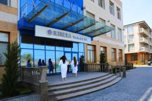 two women walking in front of a building at Ribera Resort&SPA in Yevpatoriya