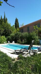 a pair of lounge chairs next to a swimming pool at LOLIFAN en PROVENCE in Brignoles