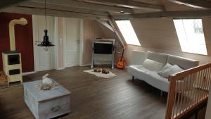 a living room with a couch and a dog laying on the floor at Ferienwohnung Grüngut in Weckersdorf